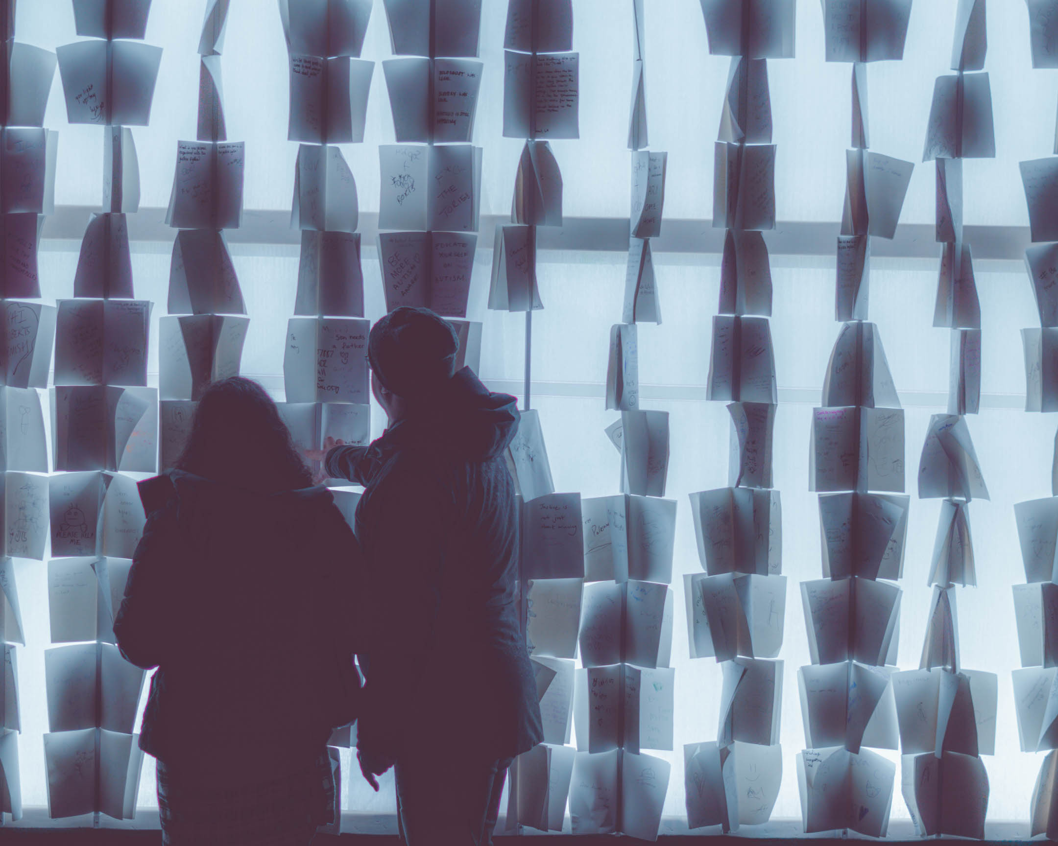 Photograph of a two people in front of a display at Lumiere.